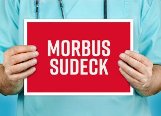 Arzt hält rotes Schild hoch - Morbus Sudeck